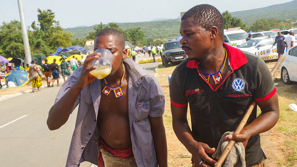 Khandzabacedza and Lugogolwemfene from Lushikishini enjoying the marula brew outside the arena of the day's events during the Buganu Ceremony. 